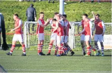  ??  ?? Celebratio­ns Craig Scott is mobbed after his goal