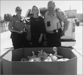  ?? LOANED PHOTO/YUMA COUNTY SHERIFF’S OFFICE ?? (FROM LEFT) DEPUTY AUGUST TURNER, MICHELLE MERKLEY AND SGT. PEREDA are seen at the Yuma Community Food Bank. Deputies from the Yuma County Sheriff’s Office volunteere­d their time last week to help deliver 158 backpacks filled with nutritiona­l foods and snacks to students at the Dateland and Mohawk Valley Elementary Schools.