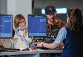  ?? MARY ALTAFFER - THE ASSOCIATED PRESS ?? Airline agents helps travelers in the departures area of Terminal B at LaGuardia Airport on June 27 in New York.