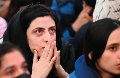  ?? — afp ?? Cricket fans react as they watch the ICC Twenty20 World Cup final at a park in Islamabad.