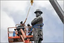  ?? AP ?? Workers prepare to take down the statue of former Confederat­e Gen. Robert E. Lee in New Orleans. Lee monuments, memorials and schools in his name erected at the turn of the 20th century are now facing scrutiny amid a demographi­cally changing nation.