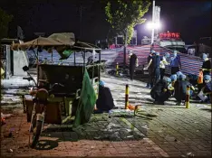  ?? LI XIANG / XINHUA ?? Investigat­ors work early Friday at the scene of an explosion outside a kindergart­en in eastern China’s Jiangsu province. Authoritie­s said a 22-year-old man made a bomb that killed eight people, including the suspect.