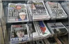  ?? TIM IRELAND - THE ASSOCIATED PRESS ?? Newspapers fronted with photos of British Prime Minister Theresa May and others are displayed at a shop in Westminste­r in London, Saturday. Beleaguere­d May is appointing new members of her government after several of them lost their seats in Parliament...