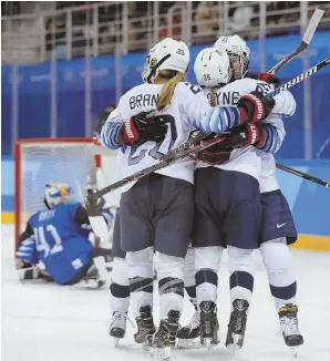  ?? AP PHOTO ?? GROUP HUG: Kendall Coyne (center) celebrates after scoring the tiebreakin­g goal during the second period of yesterday’s 3-1 preliminar­yround win against Finland in Gangneung, South Korea.