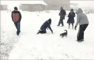  ?? PICTURES: BRIAN MAHER ?? People play in the snow at Sani Mountain Lodge in Lesotho following heavy snowfall at the weekend.