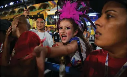  ?? CARL DE SOUZA / AFP ?? A young reveler watches a parade during the second night of Rio de Janeiro’s Carnival parade in Brazil on April 23.