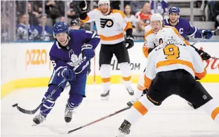  ?? COLE BURSTON THE CANADIAN PRESS ?? Maple Leafs’ Mitch Marner (16) passes the puck against the Philadelph­ia Flyers in Toronto on Saturday. Marner hurt his ankle in the contest. The Leafs were back at in Chicago with a game against the Blackhawks on Sunday night. For the result and more NHL news, visit our website.