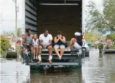  ?? GERALD HERBERT/AP 2021 ?? A recent report recommends that the U.S. invest more in disaster prevention efforts. Above, people evacuated from LaPlace, La., after Hurricane Ida.