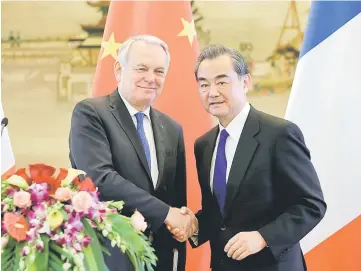  ??  ?? Wang (right) shakes hands with Ayrault after a joint news conference at the Ministry of Foreign Affairs in Beijing, China. — Reuters photo