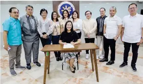  ?? ?? The Quezon City mayor (seated) inducted the new set of SPEEd officers. They are (standing from left) Eugene Asis (People's Journal), Gerry Olea (PEP.ph), Salve Asis (Pilipino Star Ngayon and Pang-Masa), Maricris Nicasio (Hataw), Dinah Ventura (Tribune), Gie Trillana (Malaya) Dondon Sermino (Abante), Ervin Santiago (Bandera), Nickie Wang (Manila Standard) and Rohn Romulo (People's Balita).