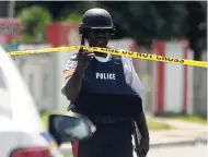  ?? PHOTOGRAPH­ER LIONEL ROOKWOOD/ ?? Police at a crime scene in August Town, St Andrew, earlier this week, after several persons were shot, one fa t a l l y.