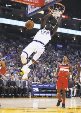  ?? Michael Macor / The Chronicle ?? Draymond Green dunks in a 120-117 win over Washington on Oct. 27. Green later mixed it up with the Wizards’ Bradley Beal (3); both players were ejected.