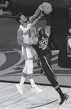  ?? MIKE EHRMANN/GETTY IMAGES ?? Miami’s Jimmy Butler, left, and Los Angeles’ LeBron James were both masterful in Game 5 of the NBA Finals. Butler had 35 points, 12 rebounds and 11 assists, while James had 40 points, 13 rebounds and seven assists.