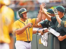  ?? Scott Strazzante / The Chronicle 2015 ?? Muncy, shown after scoring against the Giants at the Coliseum in 2015, was a .195 hitter in 96 majorleagu­e games with the A’s.