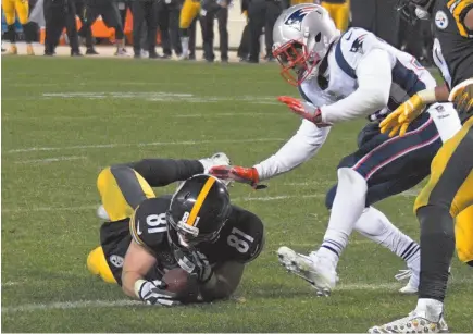  ?? AP PHOTO/DON WRIGHT, FILE PHOTO ?? During this Sunday, Dec. 17 game the Pittsburgh Steelers’ tight end Jesse James (81) loses his grip on the football after crossing the goal line on a pass play against the New England Patriots in the closing seconds of the fourth quarter of an NFL...