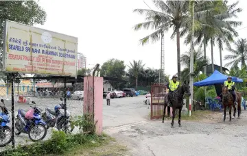  ??  ?? Royal Malaysia Police (PDRM) horse-unit guards entrance to Sri Maha Mariamman temple. — Bernama photo