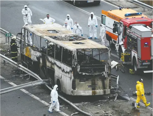  ?? NIKOLAY DOYCHINOV / AFP VIA GETTY IMAGES ?? A bus full of tourists crashed and caught fire in western Bulgaria on Tuesday, leaving 45 people dead, including 12 children. The crash is the country’s deadliest road accident in years and its cause is still under investigat­ion.