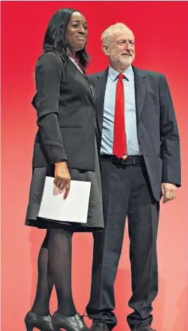  ??  ?? One of Jeremy Corbyn’s MPs has resigned from the shadow cabinet after she misled the public over what she knew about her son’s drug offences. Kate Osamor, 50, the shadow internatio­nal developmen­t secretary, had claimed she knew nothing about her son’s conviction for having drugs worth £2,500 until after he was sentenced in October. But it emerged yesterday that the MP, pictured with the Labour leader, had written to the judge asking for leniency for Ishmael Osamor, 29, who worked in her office after his conviction. When asked by a reporter about her letter, Ms Osamor said she “should have come down here with a bat and smashed your face in”, and threw a bucket of water at him.