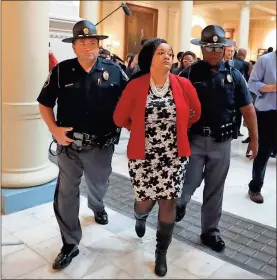  ?? / AP-John Bazemore ?? Sen. Nikema Williams, D-Atlanta, is arrested by Capitol police during a protest over election ballot counts in the rotunda of the state capitol building in Atlanta.