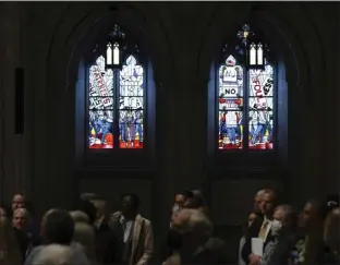  ?? NICK WASS THE ASSOCIATED PRESS ?? People listen during an unveiling and dedication ceremony at the Washington National Cathedral for the new stainedgla­ss windows with a theme of racial justice on Sept. 23 in Washington. The new windows, titled “Now and Forever,” are based on a design by artist Kerry James Marshall.