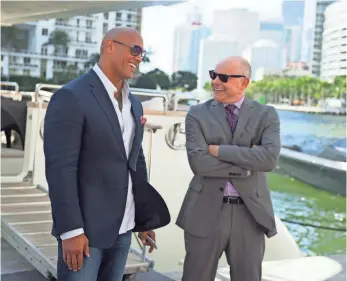  ?? JEFF DALY, HBO ?? Dwayne Johnson, left, and Rob Corddry advise pro football players on their finances in Ballers.