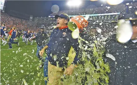  ?? TODD VAN EMST/AUBURN PHOTO ?? Auburn football coach Gus Malzahn gets a Gatorade drenching after last Saturday’s 26-14 win over Alabama.