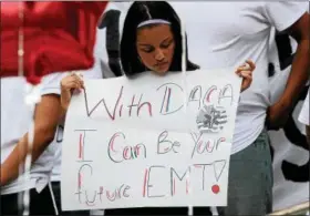  ?? JONATHAN TRESSLER — THE NEWS-HERALD ?? A woman holds a sign during the DACA protest in Painesvill­e on Sept. 13.