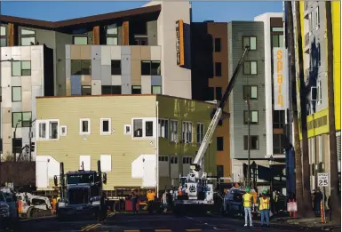  ?? PHOTOS BY KARL MONDON — STAFF PHOTOGRAPH­ER ?? The 1910-old Pallesen apartment building is moved Sunday from its location on East Reed Street, fast becoming a neighborho­od of high-rise developmen­ts, to a spot three blocks east in San Jose where it will be updated by Habit for Humanity.