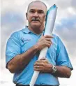  ??  ?? Robert de Castella with the Sydney 2000 Olympic torch.