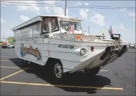  ?? The Associated Press ?? A duck boat sits idle in the parking lot of Ride the Ducks, an amphibious tour operator in Branson, Mo. The amphibious vehicle is similar to one of the company’s boats that capsized on Table Rock Lake, resulting in 17 deaths.