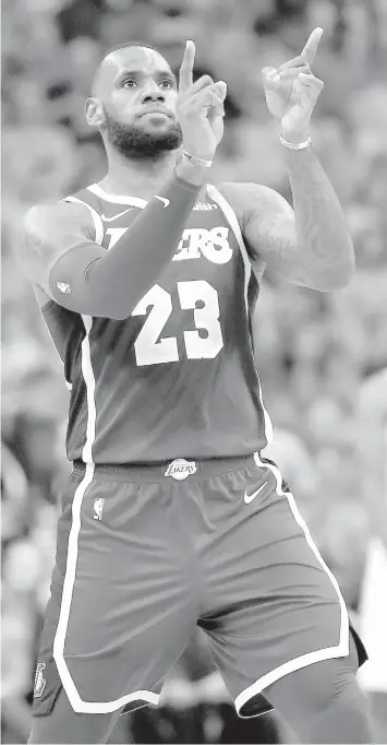  ??  ?? Los Angeles Lakers forward LeBron James celebrates a basket against the Phoenix Suns during the second half of an NBA basketball game in Phoenix. ASSOCIATED PRESS