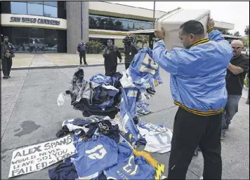  ?? DENIS POROY / AP ?? Chargers fans express their anger Thursday at the franchise’s decision to leave San Diego after failing to obtain public funding for a new stadium.
