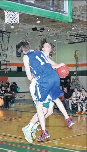  ?? TC Media photo ?? Peacock’s Eric Forbes takes a hard foul from Swift Current’s Matthew Bissonette in 4A boys regional basketball action Saturday.