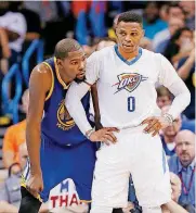  ?? [PHOTO BY NATE BILLINGS, THE OKLAHOMAN] ?? Oklahoma City’s Russell Westbrook, right, and Kevin Durant wait for play to start after a timeout during Saturday’s game at Chesapeake Energy Arena. Durant and the Warriors beat the Thunder, 130-114. The game was Durant’s first in OKC since leaving...