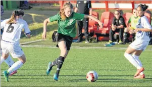  ??  ?? North Milton’s Grace Coles, centre, prepares to kick the ball during Tuesday’s soccer match between Team P.E.I. and Quebec at the Canada Games in Winnipeg.