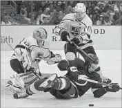  ?? Chris O’Meara Associated Press ?? ANTHONY CIRELLI of Tampa Bay is felled by Anze Kopitar in front of Kings goaltender Jonathan Quick.