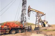  ?? HUSSEIN MALLA /ASSOCIATED PRESS ?? Syrian workers repair oil well pipes at a field controlled by a U.S-backed Kurdish group, in Rmeilan, Hassakeh province, Syria, in March 2018.