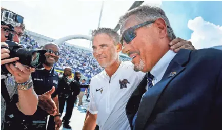  ?? COMMERCIAL APPEAL ?? University of Memphis head coach Mike Norvell (middle) and Athletic Director Tom Bowen (right) have reason to celebrate as documents reveal that Memphis is anticipati­ng an increase of $4.5 million in athletic department ticket sales and donations during fiscal year 2019 because of the hiring of Penny Hardaway as men’s basketball coach. MARK WEBER/THE