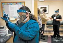  ?? E. JASON WAMBSGANS/CHICAGO TRIBUNE ?? Registered nurse Irina Salazar draws the Moderna COVID-19 vaccine Feb. 11 at the Erie West Town Health Center in Chicago.