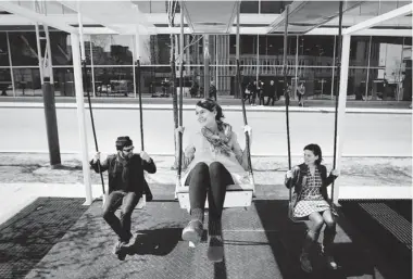  ?? DARIO AYALA/ GAZETTE FILES ?? Sound designer Radwan Ghazi Moumneh, left, and project designers Melissa Mongiat and Mouna Andraos have some fun on their 21 Swings interactiv­e installati­on at Place des Arts in downtown Montreal in April 2012.