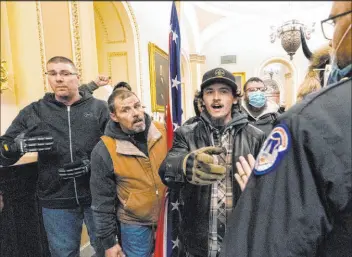  ?? Manuel Balce Ceneta
The Associated Press ?? Protesters loyal to then-president Donald Trump, including Kevin Seefried, center, are confronted by U.S. Capitol Police inside the Capitol in Washington on Jan. 6, 2021.