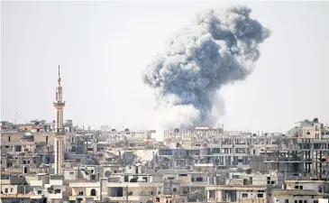  ?? AFP ?? Smoke billows in the distance following reported air strikes on the southern Syrian city of Daraa on Wednesday.