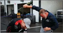  ?? AP/MATT SLOCUM ?? Will Power (left) celebrates with Nick Igdalsky of Pocono Raceway after winning the ABC Supply 500, which was stopped with 72 laps left because of severe weather.