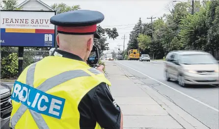  ?? BOB TYMCZYSZYN THE ST. CATHARINES STANDARD ?? Police will be at and around schools zones Tuesday for crossing guard and speed enforcemen­t. Sgt. Todd Lantz with the traffic department takes LIDAR reading of speeders last year along Bunting Road.