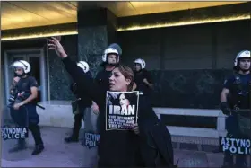  ?? (AP/Yorgos Karahalis) ?? A protester shouts slogans Saturday during a protest against the death of Iranian Mahsa Amini, outside the European Commission representa­tive office, in Athens, Greece.