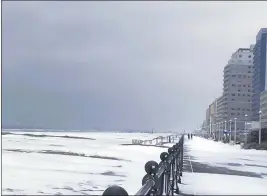  ?? STACY PARKER — THE VIRGINIAN-PILOT FOR THE ASSOCIATED PRESS ?? Snow covers the oceanfront Saturday in Virginia Beach, Va. A layer of ice and a blanket of snow have covered coastal areas.