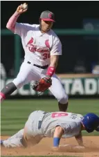  ?? (Photo by Chris Lee, St. Louis Post-Dispatch, AP) ?? St. Louis Cardinals shortstop Aledmys Diaz forces out Chicago Cubs' Ian Happ and the batter, Anthony Rizzo, was also ruled out on a slide interferen­ce call to end the top of the fifth inning of Saturday's game.