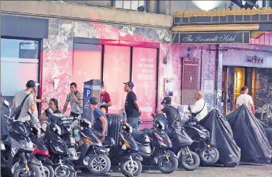  ?? ?? GET WHEEL: Work motor scooters sit at The Roosevelt Hotel migrant intake and shelter facility in Midtown.