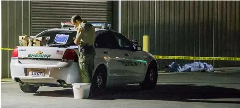  ??  ?? CALIFORNIA SHOOTING. A Kern County sheriff's deputy stands near an area where a shooting victim lies, Wednesday, Sept. 12, 2018, in Bakersfiel­d, Calif. A gunman killed five people, including his wife, before turning the gun on himself, authoritie­s said.