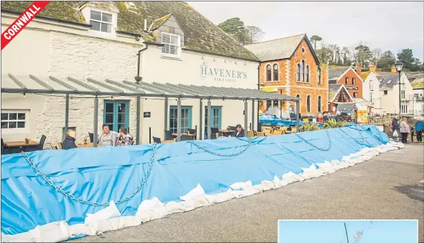  ?? Pictures: SWNS, WALES NEWS, PA, ALAMY ?? A flood defence barrier was erected at the front of this pub in Fowey as the region awaited the storm